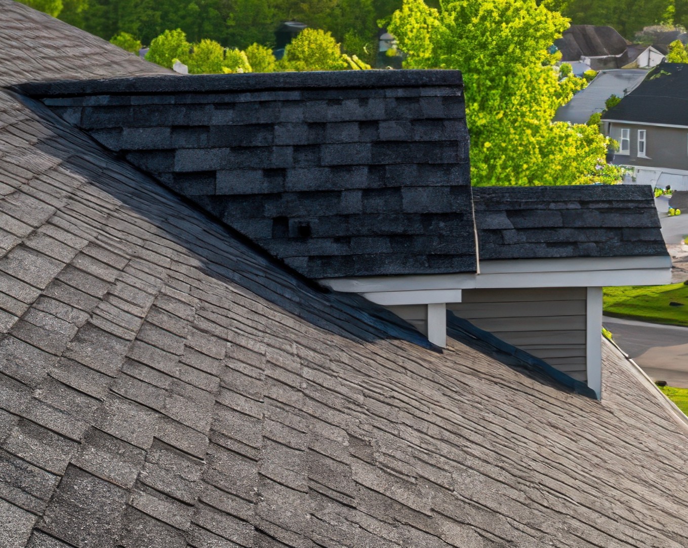 residential asphalt shingle roof close up view overlooking suburban neighborhood landscape at sunset photo